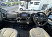 2026 Auto-Trail Frontier Delaware motorhome interior with the front cab showing the dashboard and steering wheel.