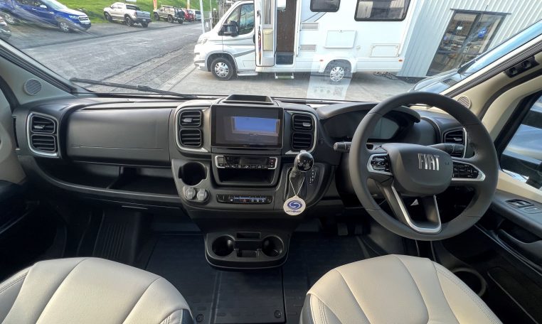 2026 Auto-Trail Frontier Delaware motorhome interior with the front cab showing the dashboard and steering wheel.
