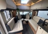 2026 Auto-Trail Frontier Delaware motorhome interior view of the spacious front lounge and swivel cab seats.