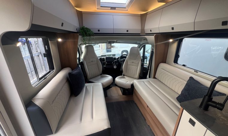 2026 Auto-Trail Frontier Delaware motorhome interior view of the spacious front lounge and swivel cab seats.