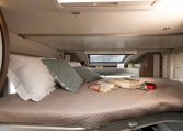 2026 Roller Team T-Line 700 interior view showing the skylight above the drop-down bed.