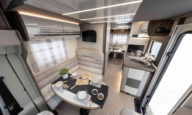 2026 Roller Team T-Line 700 interior view showing the front dining overhead storage.