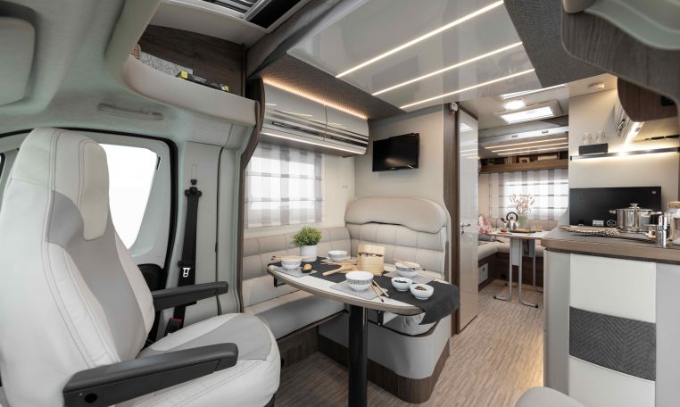 2026 Roller Team T-Line 700 interior view showing the front dining with swivel seats.