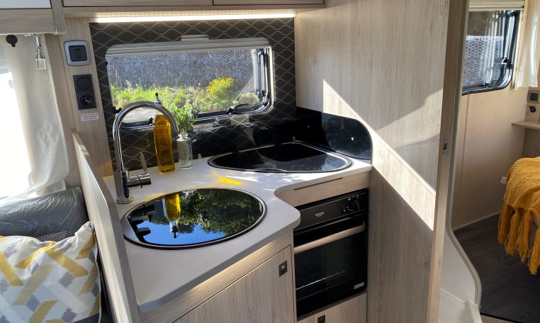 2023 Auto-Trail F-Line F74 motorhome interior view showing the kitchen with an oven and hob.