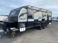 2024 Titan Blackhawk Tourer 720 Tardis caravan exterior view showing the picnic table unit.