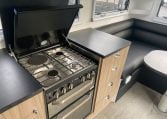 2024 Titan Blackhawk Tourer 720 Tardis caravan interior view showing the gas hob.
