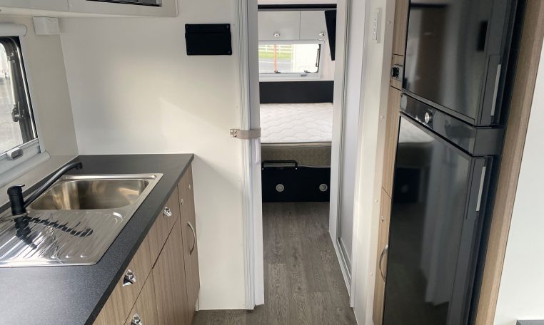 2024 Titan Blackhawk Tourer 720 Tardis caravan interior view showing the kitchen layout.