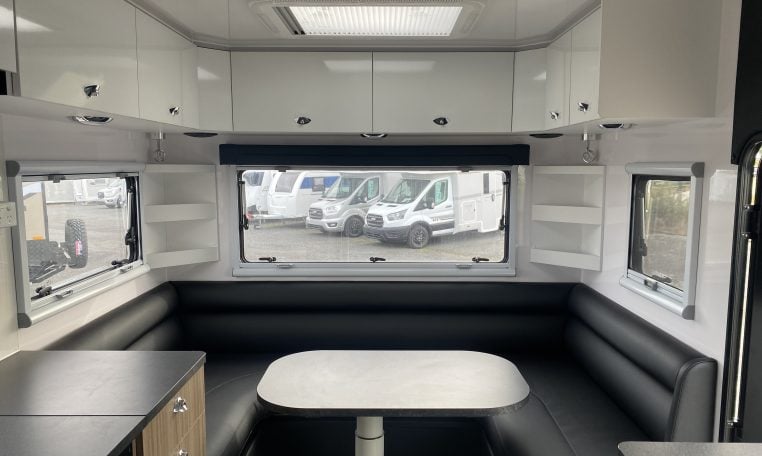 2024 Titan Blackhawk Tourer 720 Tardis caravan interior view showing the overhead cabinets.