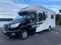 Exterior front and passenger side view of an Auto-Trail F-Line F74 motorhome showing cab, headlights, side profile, and exterior design.