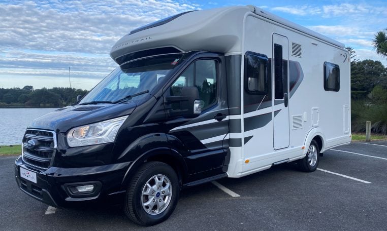 Exterior front and passenger side view of an Auto-Trail F-Line F74 motorhome showing cab, headlights, side profile, and exterior design.