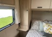 2023 Auto-Trail F-Line F74 motorhome interior view showing the bedroom window with blind pulled up.