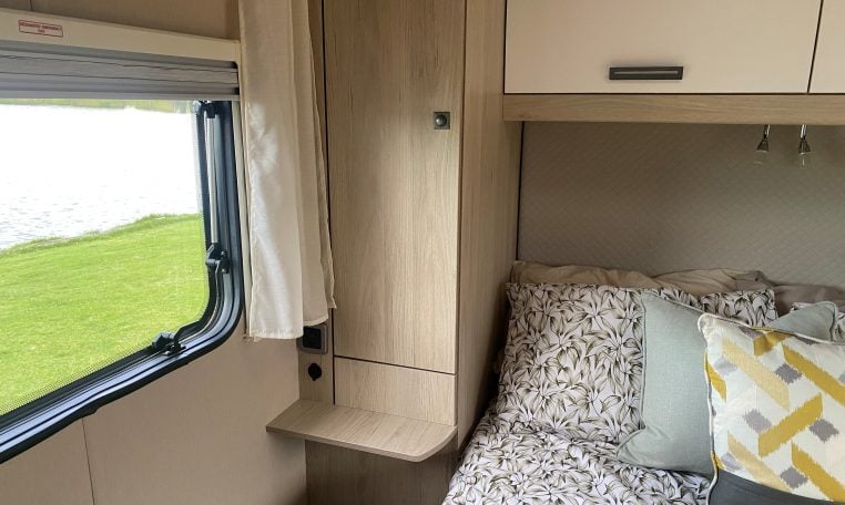 2023 Auto-Trail F-Line F74 motorhome interior view showing the bedroom window with blind pulled up.