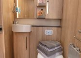 Clean, compact toilet and separate shower setup in the Auto-Trail Grand Frontier GF88, designed for comfort and space efficiency.
