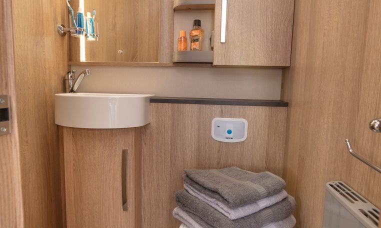Clean, compact toilet and separate shower setup in the Auto-Trail Grand Frontier GF88, designed for comfort and space efficiency.