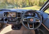 Fiat Ducato Pilote G740FC motorhome interior view showcasing the steering wheel and dash in the cab area.