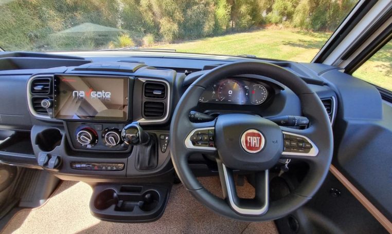 Fiat Ducato Pilote G740FC motorhome interior view showcasing the steering wheel and dash in the cab area.